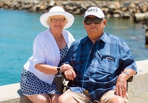 senior couple sitting in the sun near a waterway in florida